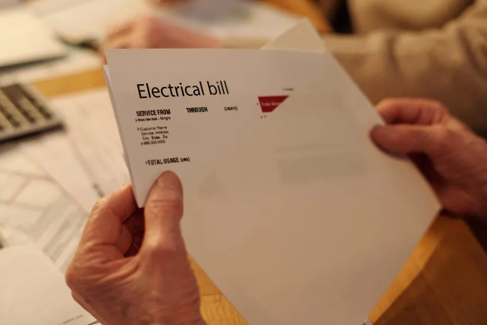 man holding energy bill he recieved